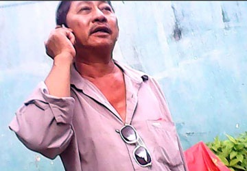 “Chiêu bài”… mang bầu giả! - 2 Ông Sáu đang gọi điện thoại tìm “mối” cho con mới sinh. Ảnh: TRẦN NGỌC