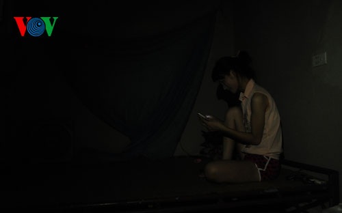 Trong căn phòng tối om, Yến chỉ biết giải trí bằng chiếc điện thoại di động.