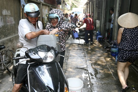 Chiếc xe téc hết nước, người dân bắt đầu bình tĩnh hơn để mang nước về nhà.