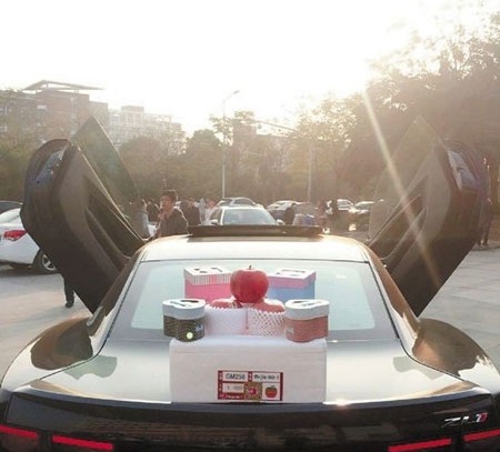 Những chiêu trò "khoe của" mới của nhà giàu Trung Quốc - 2 Một tiểu thư Trung Quốc dùng siêu xe làm quầy hàng để bán táo