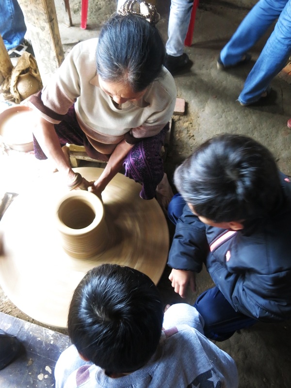 Du khách xem thợ làng nghề khéo léo tạo nên những sản phẩm làm từ đất sét