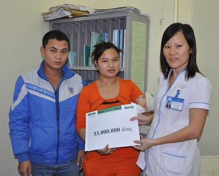 Điều dưỡng trưởng khoa Nhi, Nguyễn Thị Thu Thanh trao tiền đến gia đình bé Hà Phương.