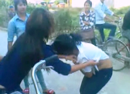 Xung quanh có nhiều học sinh khác đứng xem.