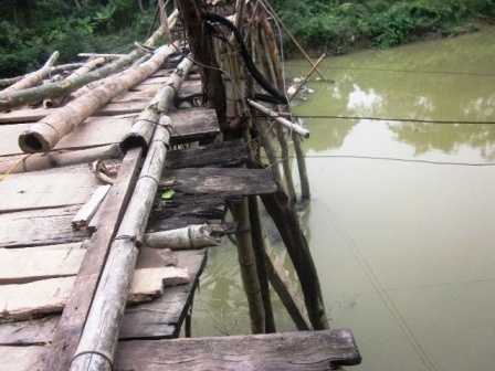 Cầu mục nát “cõng” hàng trăm lượt người mỗi ngày - 3 Những tấm gỗ trên mặt cầy đã bị mục nát.