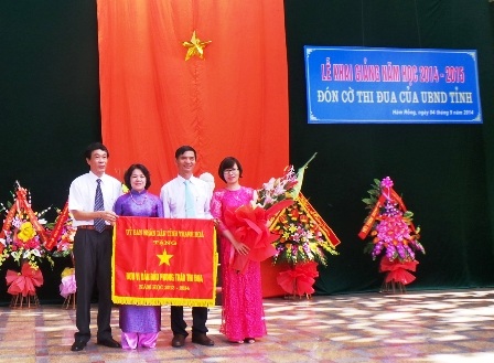 Lãnh đạo nhà trường đón nhận cờ thi đua của UBND tỉnh Thanh Hóa. (Ảnh Duy Tuyên)