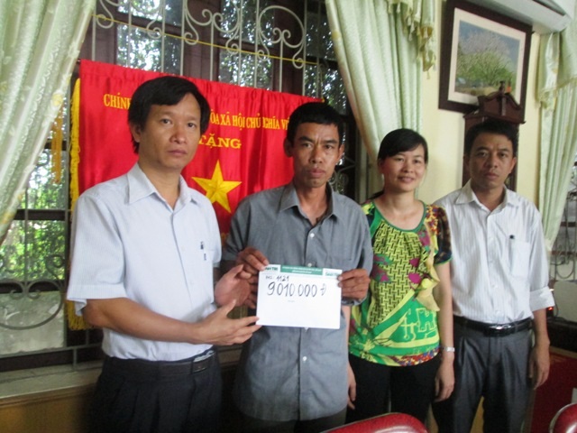 Đại diện Ban giám hiệu trường THPT Lương Đắc Bằng trao quà bạn đọc đến gia đình em Mai Thơ