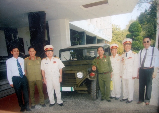 Ông Đào Ngọc Vân và đồng đội cũ chụp ảnh lưu niệm bên chiếc xe Jeep vừa được phục dựng.