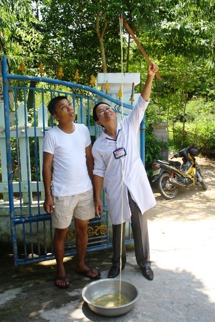 Phát hiện sán xơ mít “khủng” dài 12m trong ruột người - 1 Y sĩ Lê Công Danh (phải) đang kiểm tra con sán