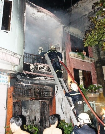 Đổ đèn cầy, nhà 2 tầng bùng cháy trong mưa - 2