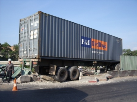 Xe container nằm vắt ngang rào chắn công trình  - 1