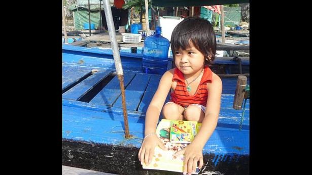 Một bé gái tại Làng chài Vung Viêng e dè khi được nhận quà