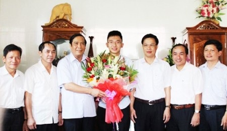 Hà Tĩnh: 2 học sinh vào đội tuyển dự thi Olympic Toán quốc tế - 2 Đại diện lãnh đạo tỉnh Hà Tĩnh tặng hoa chúc mừng em Võ Anh Đức. (Ảnh: BHT)
