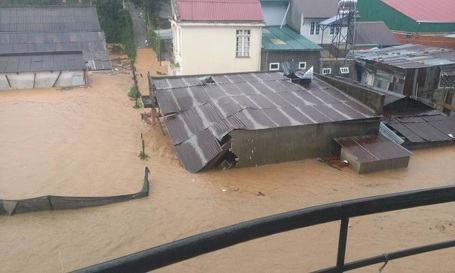 Cả ngôi nhà anh Nghĩa và các ngôi nhà lân cận đều chìm trong mênh mông nước.