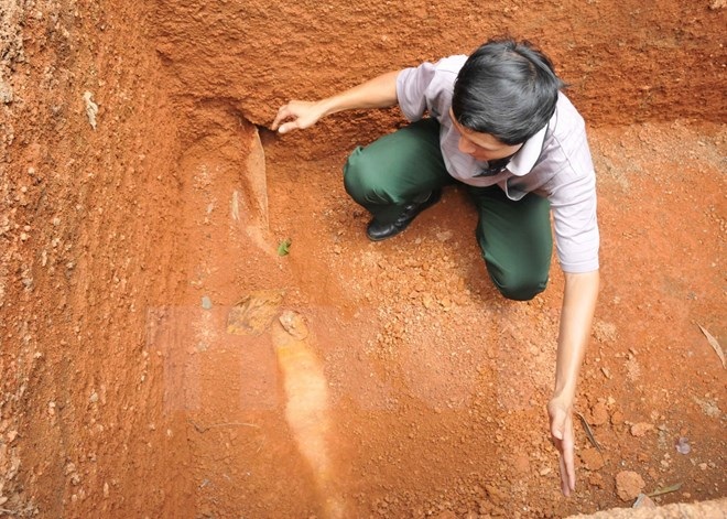 Phát hiện 1 quả bom "khủng" 200kg trong nhà dân - 1 Anh Khoa với quả bom phát hiện khi đào bể xử lý nước thải.(Ảnh: Đậu Tất Thành/TTXVN)