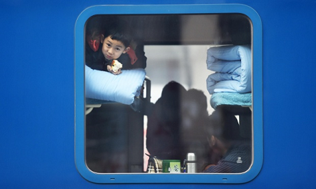 Những con số ấn tượng về Tết âm lịch 2015 ở Trung Quốc - 5 Một bé trai đang đợi tàu khởi hành tại nhà ga ở thành phố Hắc Long Giang. (Ảnh: