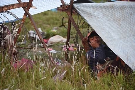 Nepal: Người dân đổ ra đường sau động đất, biến thủ đô thành khu trại lều - 7 Một người dân Nepal ngồi nghe điện thoại trong một lều trại ngoài trời tại thủ đô. (Ảnh: