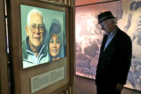 Một người phụ nữ chụp cùng một tấm poster trong triển lãm.