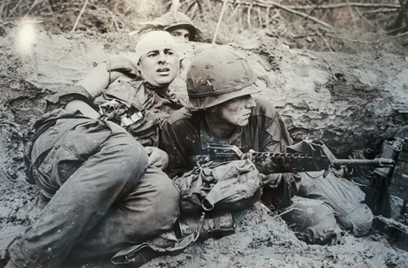 Một người lính Mỹ mang súng trường nằm bên cạnh đồng đội bị thương tại Phước Vinh 1967.