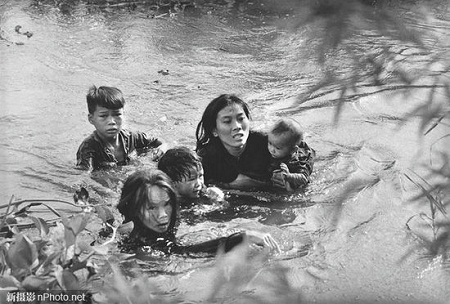Việt Nam trong những bức ảnh đoạt giải ảnh Báo chí Thế giới - 2 1965: Một người mẹ đang cùng các con bơi qua sông để thoát khỏi cuộc ném bom của những máy bay Mỹ.