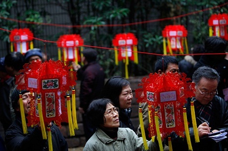 Một người bán hàng dạo với chùm bóng bay hình trái tim trên đường phố Bắc Kinh.