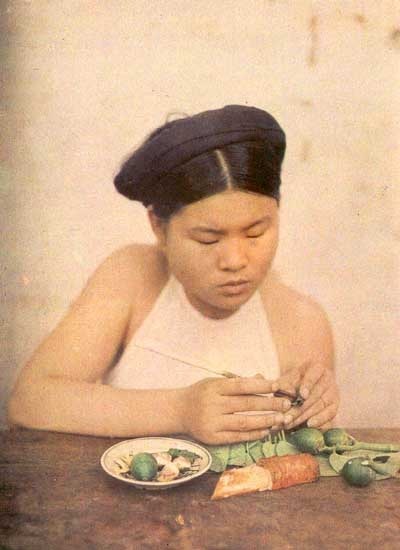 Vẻ đẹp “không thể trộn lẫn” của phụ nữ Việt Nam đầu thế kỷ 20 - 28 Một phụ nữ đang têm trầu. Ảnh chụp tại Hà Nội năm 1916.
