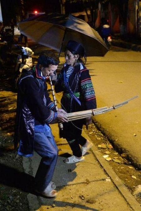 Giang A Vang thổi khèn và vợ Vang Thi Xo múa theo điệu nhạc.