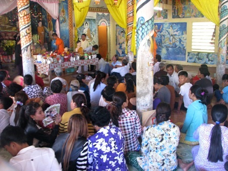 Từ đầu giờ chiều, người dân mang nước và hoa đến chùa và ngồi chờ đến giờ tắm cho Phật.