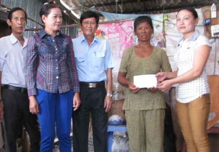 Đại diện MTTQ huyện Đông Hải trao hỗ trợ bà Phượng.