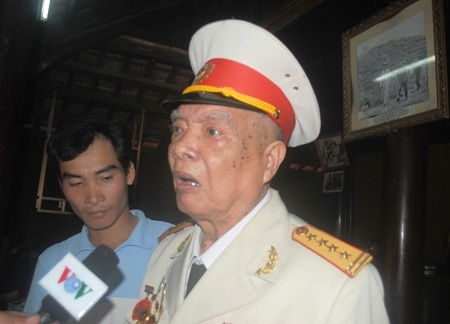 Anh Phạm Xuân Hóa rưng rưng ôm lấy bức hình của Đại tướng với quê hương Lệ Thủy