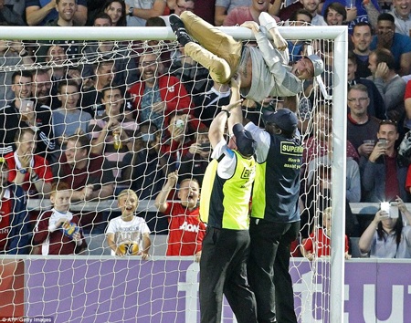 Một cổ động viên cuồng nhiệt dứt khoát phải ôm... xà ngang