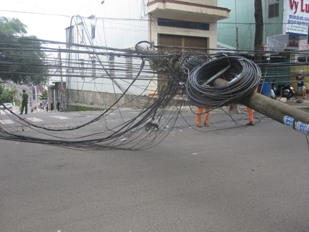 Nhiều người đi đường được phen hú vía vì cây cột điện bị gãy kéo theo mớ dây điện bùng nhùng.