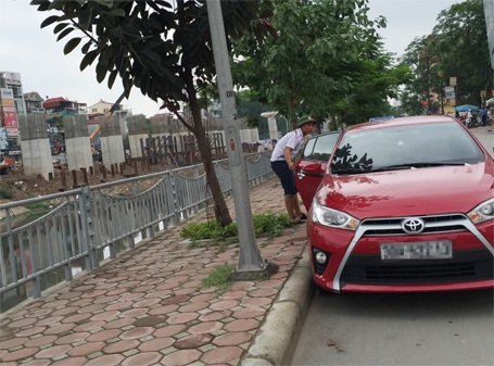 Hà Nội: Ngang nhiên “chiếm” đường “trấn lột” tiền đỗ xe ô tô - 1 Nam thanh niên đang chuẩn bị trấn lột tiền đậu xe của chủ phương tiện ô tô tại đường Giáp Nhất