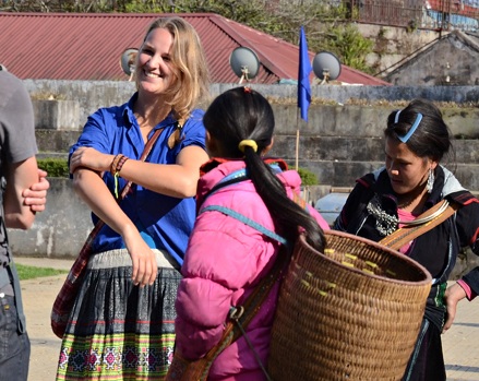 Nụ cười của cô gái quốc tịch Pháp khi thử một chiếc váy của đồng bào dân tộc Mông