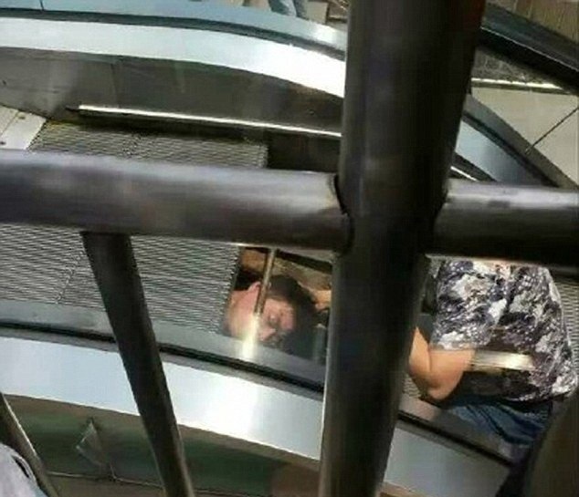 Người đàn ông bị cuốn vào trong thang máy, chỉ còn đầu hở ra ngoài.