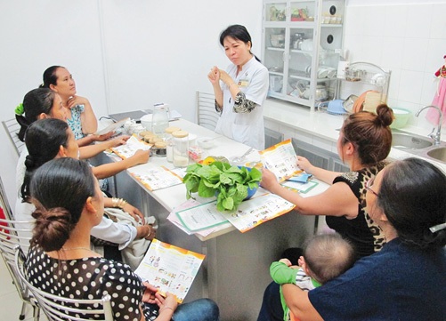 Kiểm soát tình trạng béo phì ở học sinh - 1 Tư vấn cho mẹ để có bữa ăn đủ dinh dưỡng cho con. (Ảnh: Phương Vy - TTXVN)