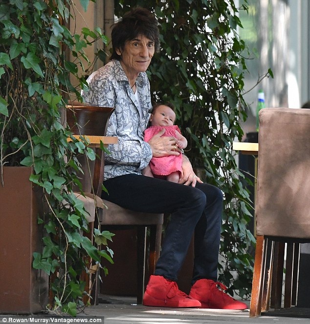 69 tuổi, sao của nhóm Rolling Stones bận rộn chăm con "mọn" - 3
Ronnie bế con gái trên tay trong khi vợ đang mải mê trò chuyện với một người bạn khác giới. Ngôi sao 69 tuổi có tổng cộng 6 người con.