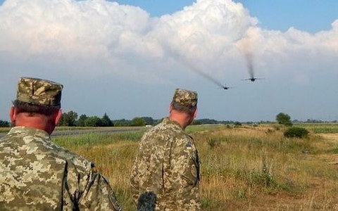 Căng thẳng Nga-Ukraine: Chưa có lý do để thỏa hiệp - 1 Hai binh sĩ Ukraine theo dõi cường kích Su-24 của Nga tập trận tại khu vực biên giới với Ukraine. Ảnh Reuters.