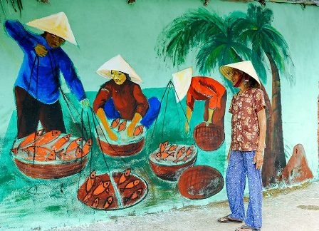 “Làng bích họa” góp phần vào phát triển văn hóa du lịch ở địa phương - 5 Một cụ bà trong làng xem bức vẽ cuộc sống đời thường