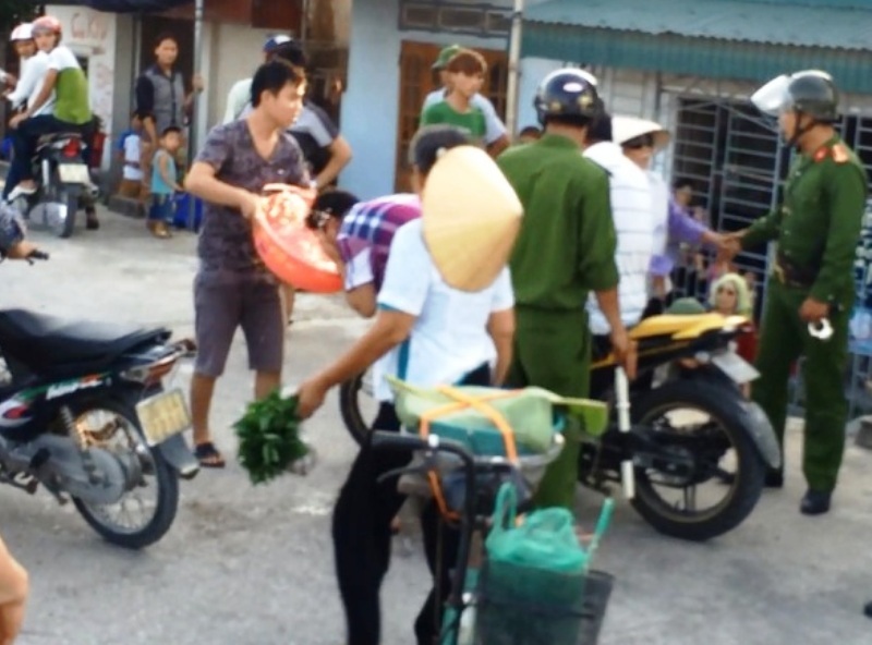 Đình chỉ cán bộ công an xịt hơi cay vào mặt dân - 2 Anh Tập được người dân múc nước cho rửa mặt sau khi bị xịt hơi cay (Ảnh cắt từ clip)