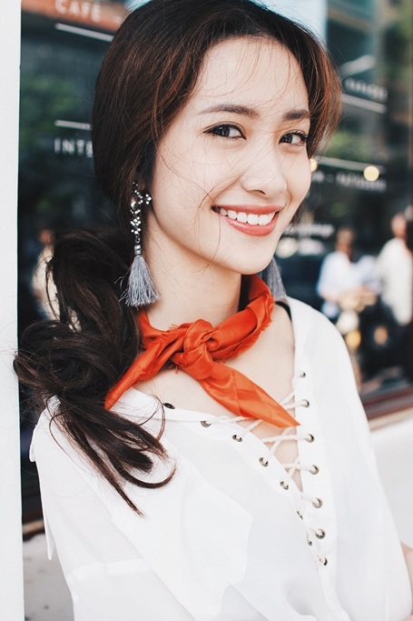 Với kiểu áo khoe nét nữ tính của cổ và vai, khăn lụa vuông với màu cam rực rỡ thắt hờ và hoa tai tua rua là cách hoàn hảo để làm điểm nhấn và che đi những khoảng trống.