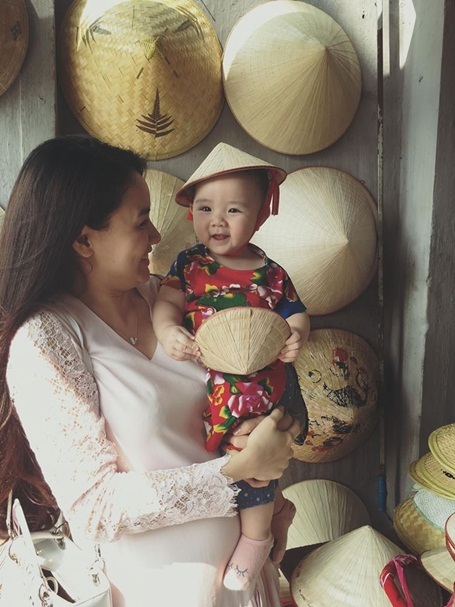 Nhóc tì 10 tháng tuổi nhà Trang Nhung điệu đà áo dài, nón lá - 6 Lần đầu được đội nón lá, Vani tỏ ra rất thích thú.