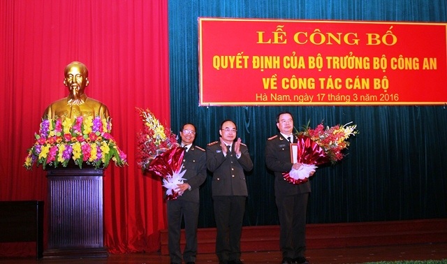 Thượng tướng Bùi Quang Bền trao quyết định, tặng hoa chúc mừng Đại tá Nguyễn Văn Trung và Đại tá Phạm Hồng Tuyến (Ảnh: Công an Hà Nam)