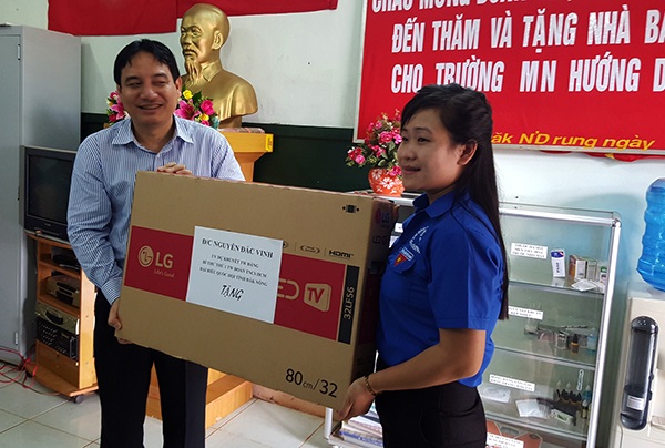 Bí thư T.Ư Đoàn kiểm tra xây dựng nhà bán trú cho HS nghèo - 2 Anh Nguyễn Đắc Vinh (trái) tặng quà cho trường mầm non Hướng Dương