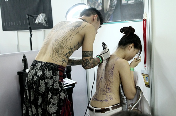 Nữ người mẫu xăm kín lưng để tham dự cuộc thi của Đại hội xăm hình quốc tế tại Hà Nội.