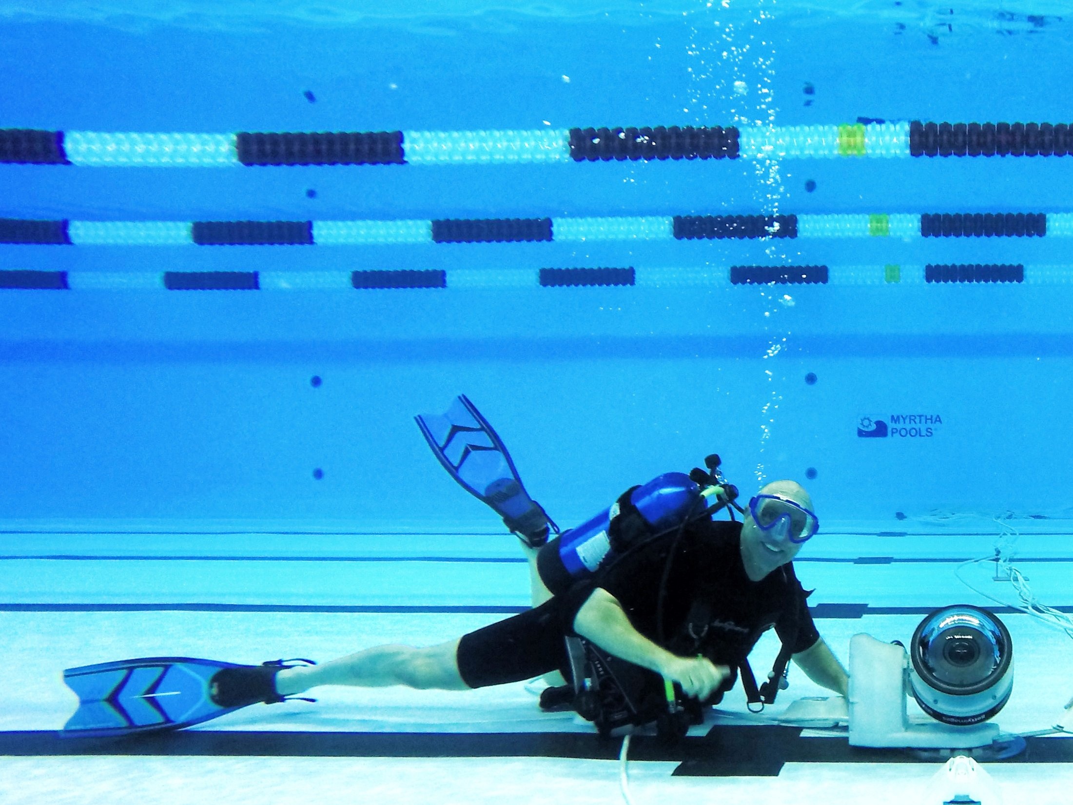 Phóng viên ảnh Al Bello lắp đặt các thiết bị để sẵn sàng chụp hình tại sự kiện thể thao dưới nước ở Olympic.