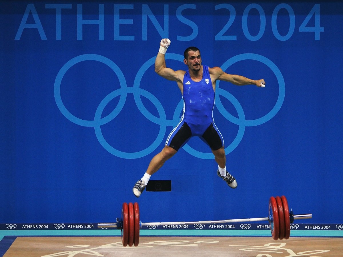 Al Bello hiện đang có mặt ở Rio để đưa tin ảnh về sự kiện Thế vận hội Olympic. Đây đã là lần thứ 11 anh đưa tin ảnh thể thao về sự kiện thuộc vào hàng lớn nhất hành tinh. Ảnh: Vận động viên Pyrros Dimas của Hy Lạp sau cú đẩy tạ thành công tại Olympic Athens 2004.