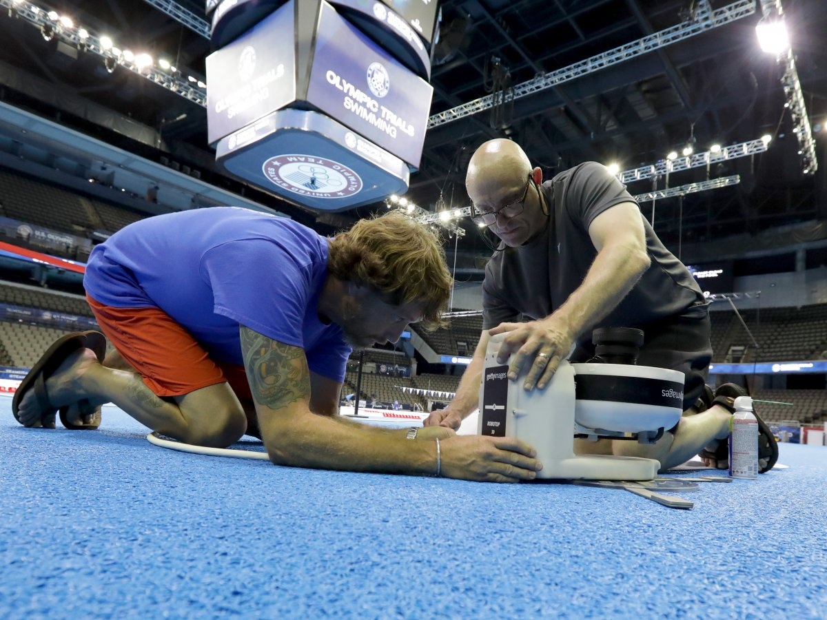 Trước mỗi buổi chụp hình tại các sự kiện thể thao dưới nước, Al Bello đều phải lắp đặt máy ảnh trong những thiết bị chống thấm nước. Ảnh: Bello (bên phải) và một đồng nghiệp đang chuẩn bị máy ảnh để tác nghiệp.