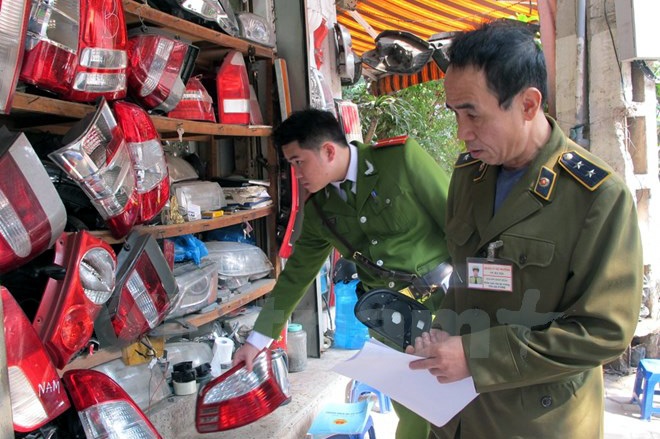 Hà Nội: Tạm giữ hàng nghìn phụ tùng ô tô nghi vấn ở “chợ Giời” - 1 Lực lượng chức năng kiểm tra các cửa hàng kinh doanh phụ tùng ô tô quanh chợ Giời. (Ảnh: TTXVN)