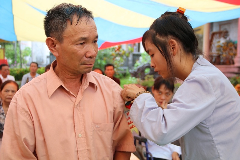 Cài những bông hoa hồng lên áo cho các đạo hữu thể hiện lòng thành kính tri ân, tình người.