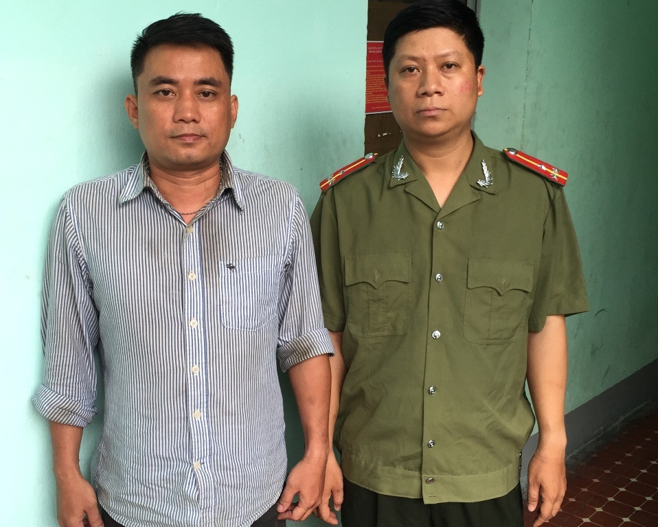 Đối tượng Chu Ngọc Hải trong trang phục thượng úy an ninh và đối tượng Ngô Tấn Hoàng Anh